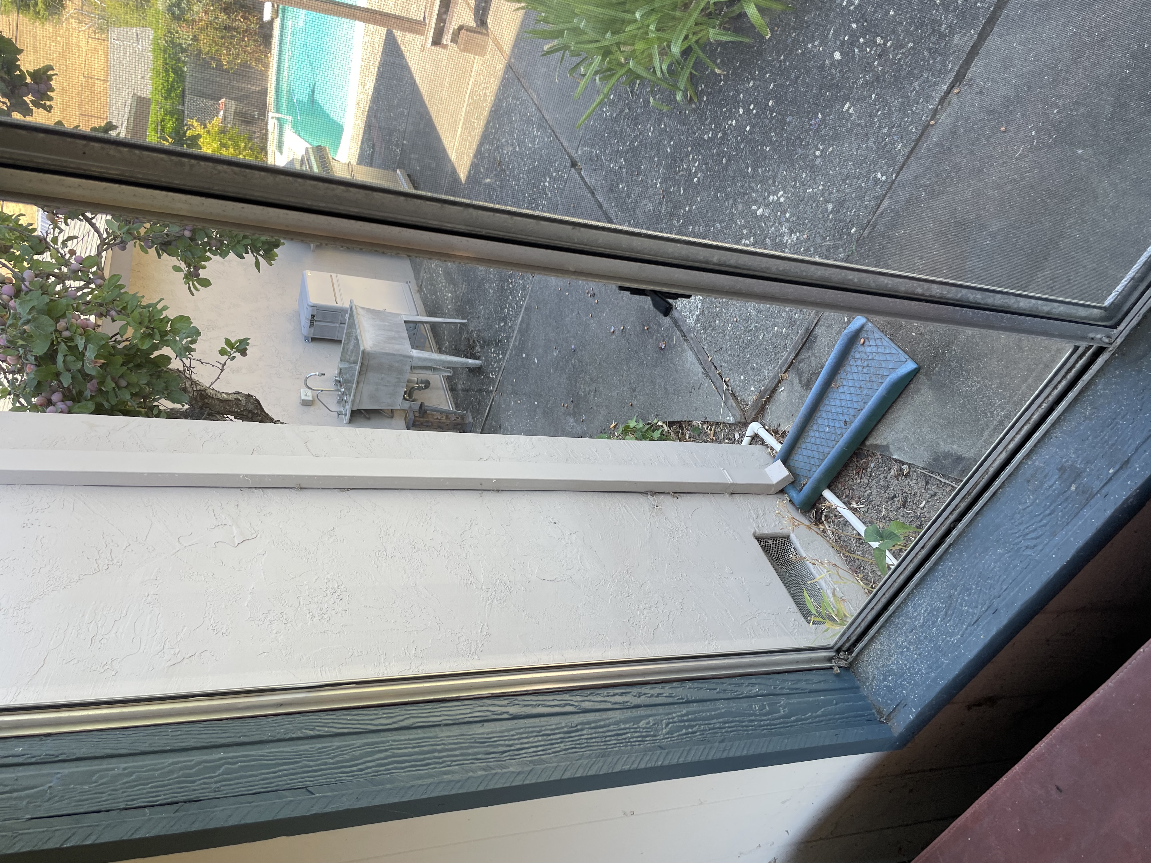 Heavily soiled sliding glass door with thick grime, dirt, and debris covering the glass