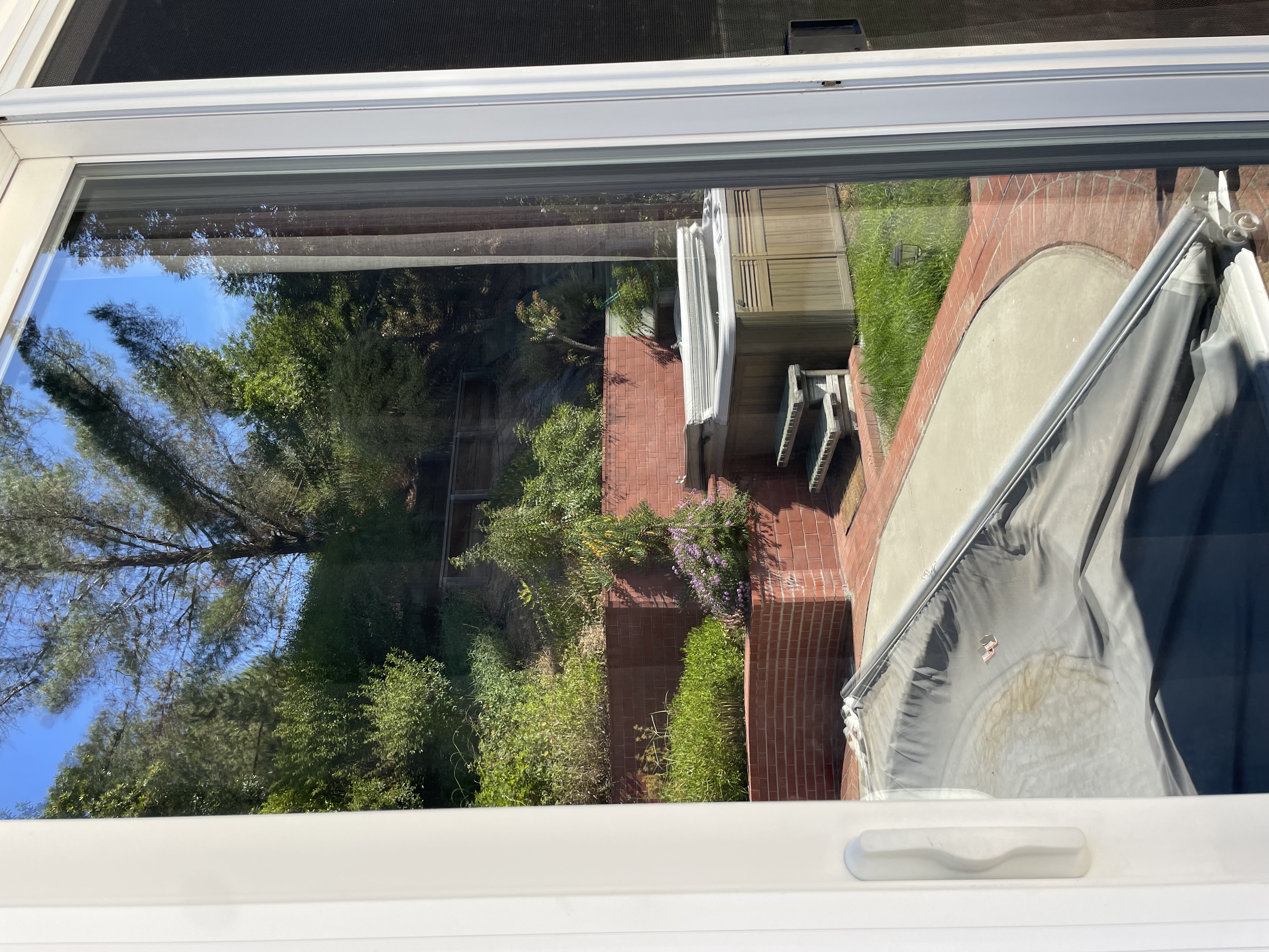 Sliding glass door with crystal clear glass showing perfect visibility of the beautiful backyard